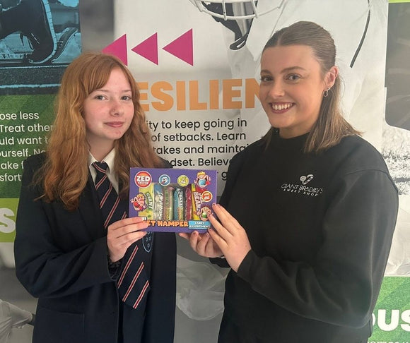 Ruby from Giant Bradley’s Sweet Shop presenting 100% attendance reward prizes at The Market Weighton School